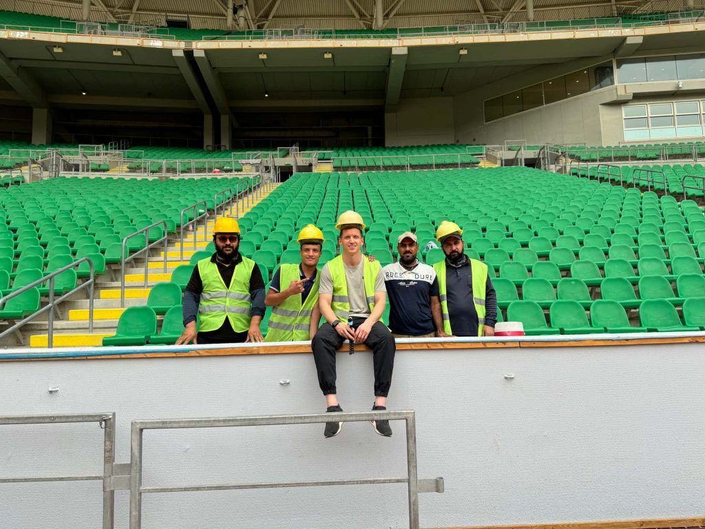 David Simpson with local workers at Basra International Stadium in Iraq. Private tour of Saddam's yacht