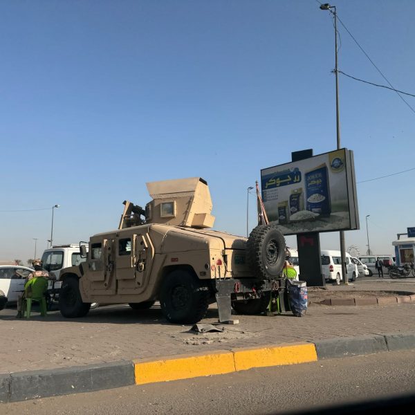 Military humvee in a parking lot in Iraq. A tour around Baghdad & the Al Anbar