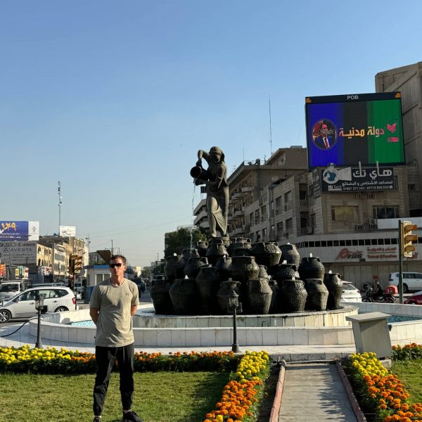 David Simpson standing by landmark in Iraq. A tour around Baghdad & the Al Anbar