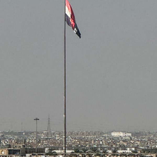 Flag at Wadi Al Salam cemetery in Iraq. World’s largest cemetery & sweets