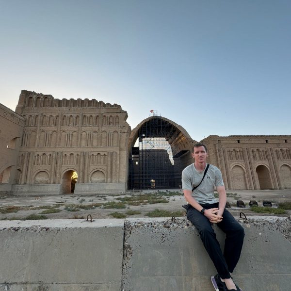 David Simpson seated near ruins in Iraq. Saddam’s Palace & old town Baghdad