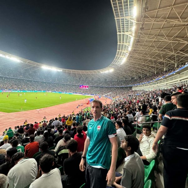 David Simpson and spectators at stadium in Basra in Iraq. Iraq v Indonesia in Basra