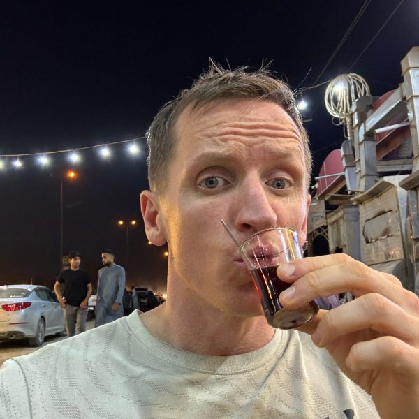 David Simpson drinking tea in Najaf in Iraq. Arm wrestling in the Iraqi marshlands