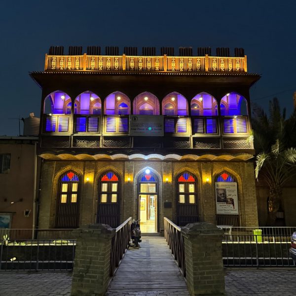 Colorful lighted Basra building at night in Iraq. Private tour of Saddam's yacht