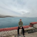 David Simpson seated by the lake in Tibet. My most horrifying travel experience